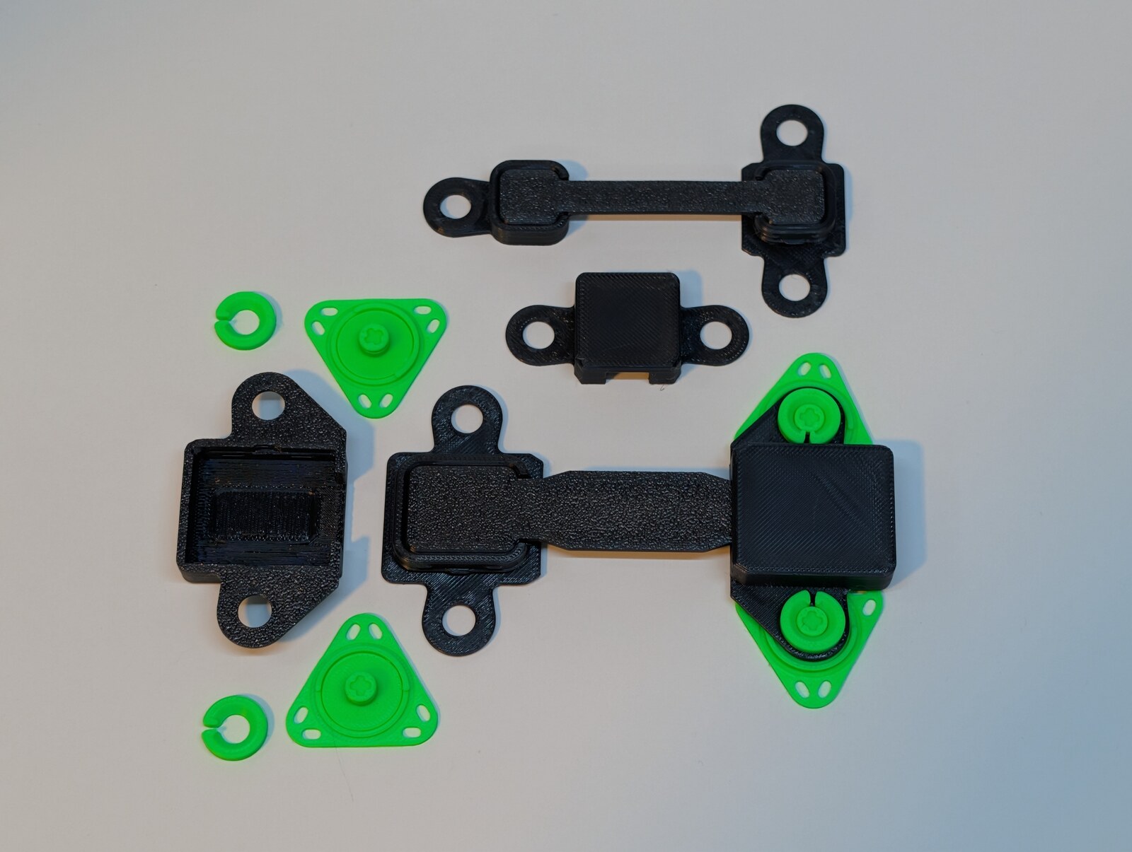 Real printed selection of Standard and Mini straps, bases, hoods and mounting parts.