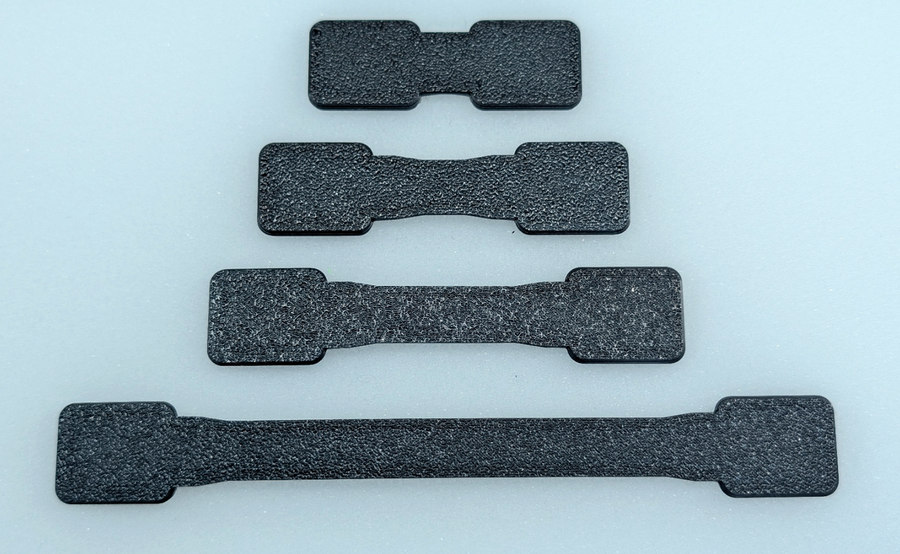 Four real Standard flat strap lengths with print texture visible.